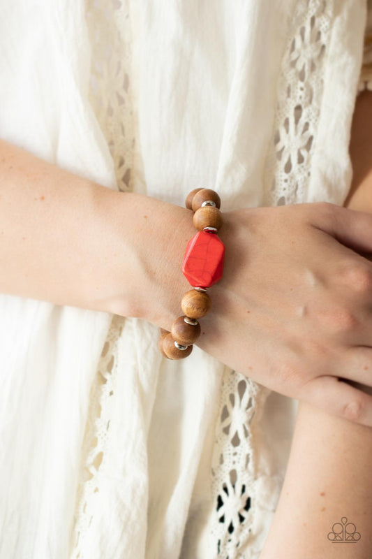 Abundantly Artisan Red Wood Bracelet - Paparazzi Accessories  Oversized brown wooden beads and mismatched red stone accents are separated by dainty silver discs and threaded along a stretchy band, creating an earthy centerpiece around the wrist.  Sold as one individual bracelet.