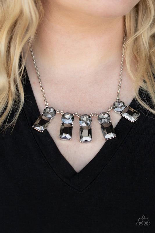 Celestial Royal Silver Necklace - Paparazzi Accessories  Featuring classic pronged fittings, a dramatic collection of oversized smoky rhinestones and emerald cut hematite gems fan out below the collar for an outrageous sparkle. Features an adjustable clasp closure.  All Paparazzi Accessories are lead free and nickel free!  Sold as one individual necklace. Includes one pair of matching earrings.