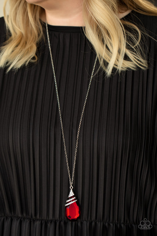 Demandingly Diva Red Necklace - Paparazzi Accessories  Capped in a white rhinestone encrusted fitting, glittery silver ribbons of white rhinestones delicately wrap around the top of a dramatically oversized red teardrop gem. The fiery red pendant swings from the bottom of a lengthened silver chain, creating a glamorous statement piece. Features an adjustable clasp closure.  All Paparazzi Accessories are lead free and nickel free!  Sold as one individual necklace. Includes one pair of matching earrings.