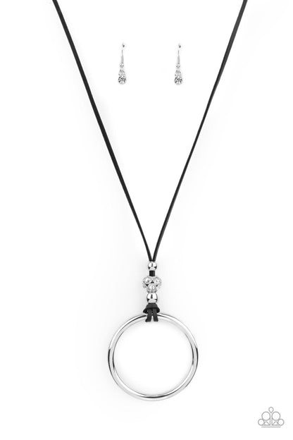 BLING Into Focus Black Necklace - Paparazzi Accessories  Infused with a pair of classic silver beads and a white rhinestone encrusted accent, lengthened black leather cording knots around a bold silver hoop for a knockout look. Features an adjustable clasp closure.  Sold as one individual necklace. Includes one pair of matching earrings.