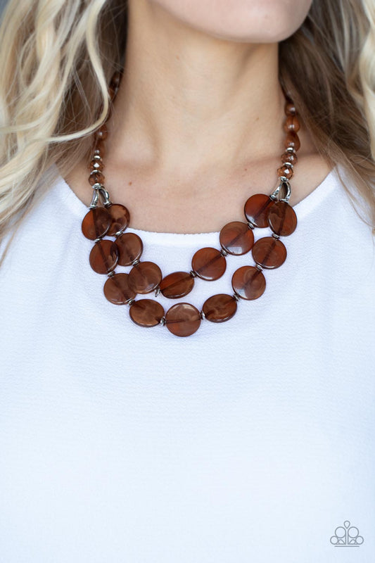 Beach Day Demure Brown Necklace - Paparazzi Accessories  Intermixed with glassy crystal-like beads and shiny silver accents, mismatched cloudy, glassy, and opaque brown teardrop and disc beads layer below the collar for a classic pop of neutral color. Features an adjustable clasp closure.  Sold as one individual necklace. Includes one pair of matching earrings.