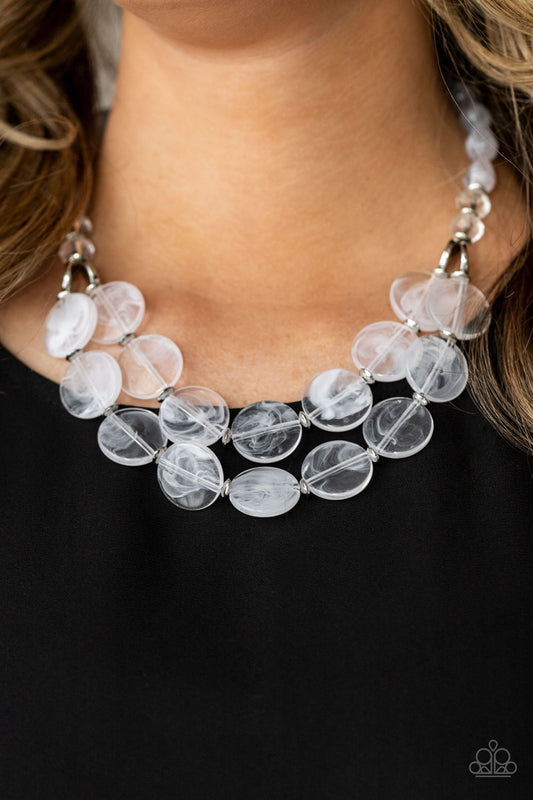 Beach Day Demure White Necklace - Paparazzi Accessories  Intermixed with glassy crystal-like beads and shiny silver accents, mismatched cloudy, glassy, and opaque white teardrop and disc beads layer below the collar for a classic pop of neutral color. Features an adjustable clasp closure.  Sold as one individual necklace. Includes one pair of matching earrings.
