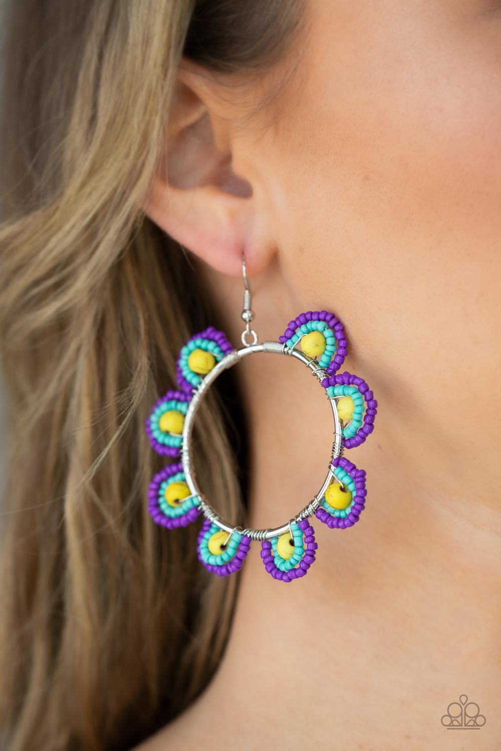 Groovy Gardens Yellow Earring - Paparazzi Accessories  Infused with sunny yellow stone bead centers, rows of purple and turquoise seed beads are threaded along dainty wires along the outside of a shiny silver hoop for a vivacious floral look. Earring attaches to a standard fishhook fitting.  Sold as one pair of earrings.