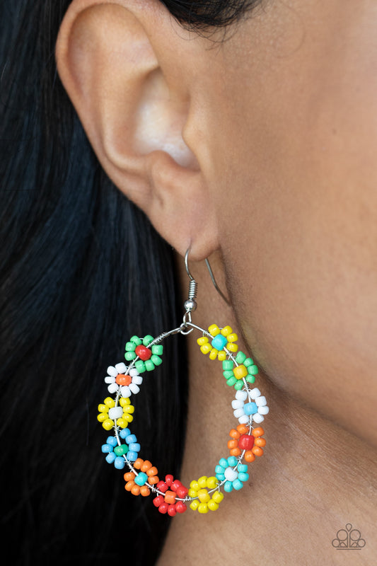Festively Flower Child Multi Earring - Paparazzi Accessories  Dotted with mismatched multicolored beaded centers, a dainty collection of multicolored seed beaded floral frames are threaded along a wire hoop for a fabulous floral fashion. Earring attaches to a standard fishhook fitting.  All Paparazzi Accessories are lead free and nickel free!  Sold as one pair of earrings.