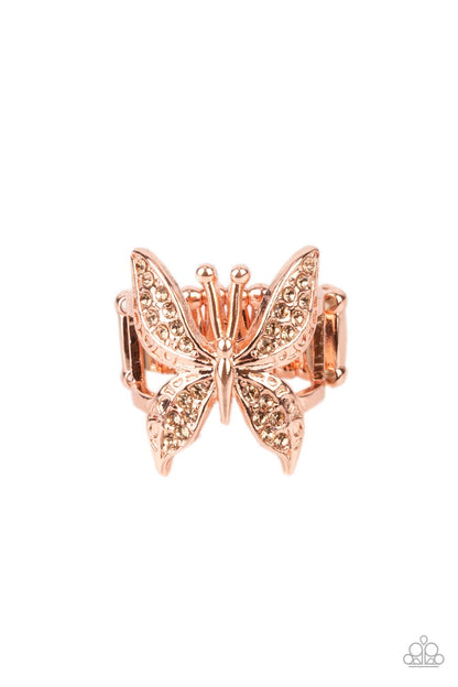 Blinged Out Butterfly Copper Ring - Paparazzi Accessories  Glittery sections of peach rhinestones delicately encrust the decorative wings of a shiny copper butterfly, creating a whimsically fluttering centerpiece atop the finger. Features a stretchy band for a flexible fit.  Sold as one individual ring.