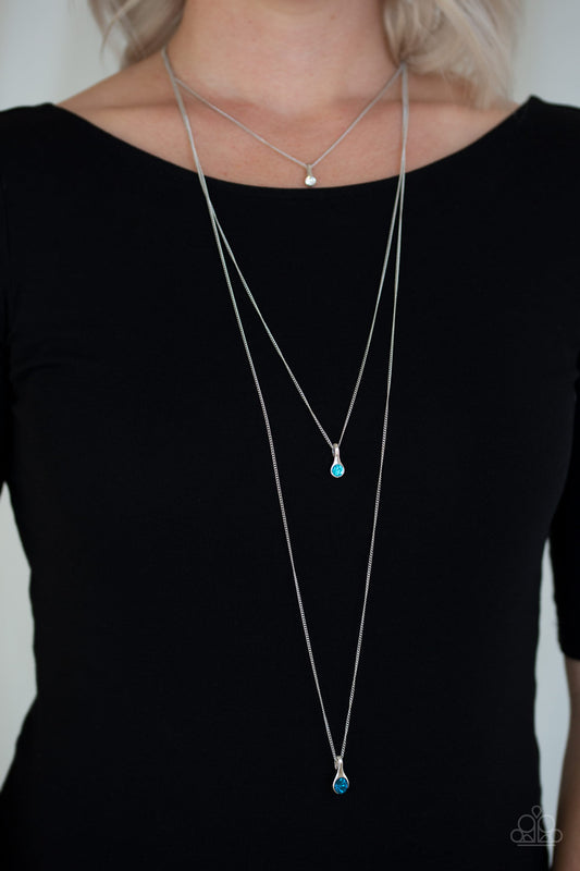Crystal Chic - Blue Item #JJG-N651 Gradually increasing in size as they drip down the chest, a trio of white, light blue and blue rhinestone pendants trickle from the bottoms of layered silver chains for a delicate ombre effect. Features an adjustable clasp closure. All Paparazzi Accessories are lead free and nickel free!  Sold as one individual necklace. Includes one pair of matching earrings.