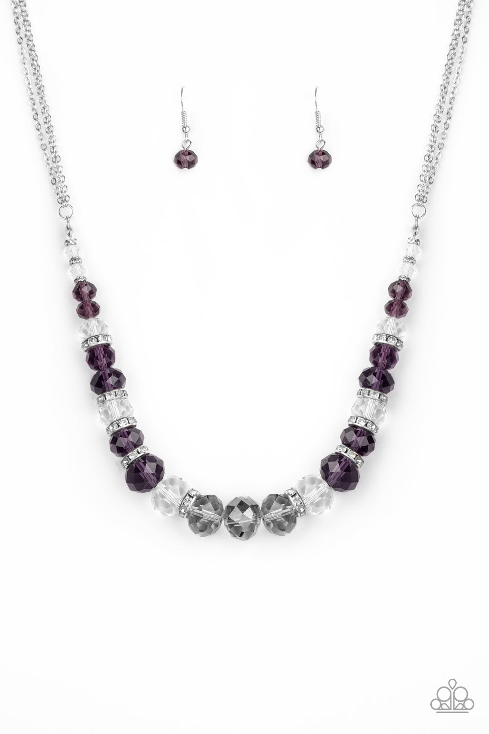 Distracted by Dazzle - Purple Item #N538 Attached to strands of shimmery silver chains, a glittery collection of purple, smoky, and white crystal-like gems and white rhinestone encrusted silver rings are threaded along an invisible wire below the collar for a glamorous finish. Features an adjustable clasp closure. All Paparazzi Accessories are lead free and nickel free!  Sold as one individual necklace. Includes one pair of matching earrings.
