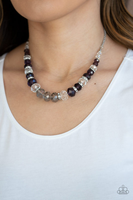Distracted by Dazzle - Purple Item #N538 Attached to strands of shimmery silver chains, a glittery collection of purple, smoky, and white crystal-like gems and white rhinestone encrusted silver rings are threaded along an invisible wire below the collar for a glamorous finish. Features an adjustable clasp closure. All Paparazzi Accessories are lead free and nickel free!  Sold as one individual necklace. Includes one pair of matching earrings.
