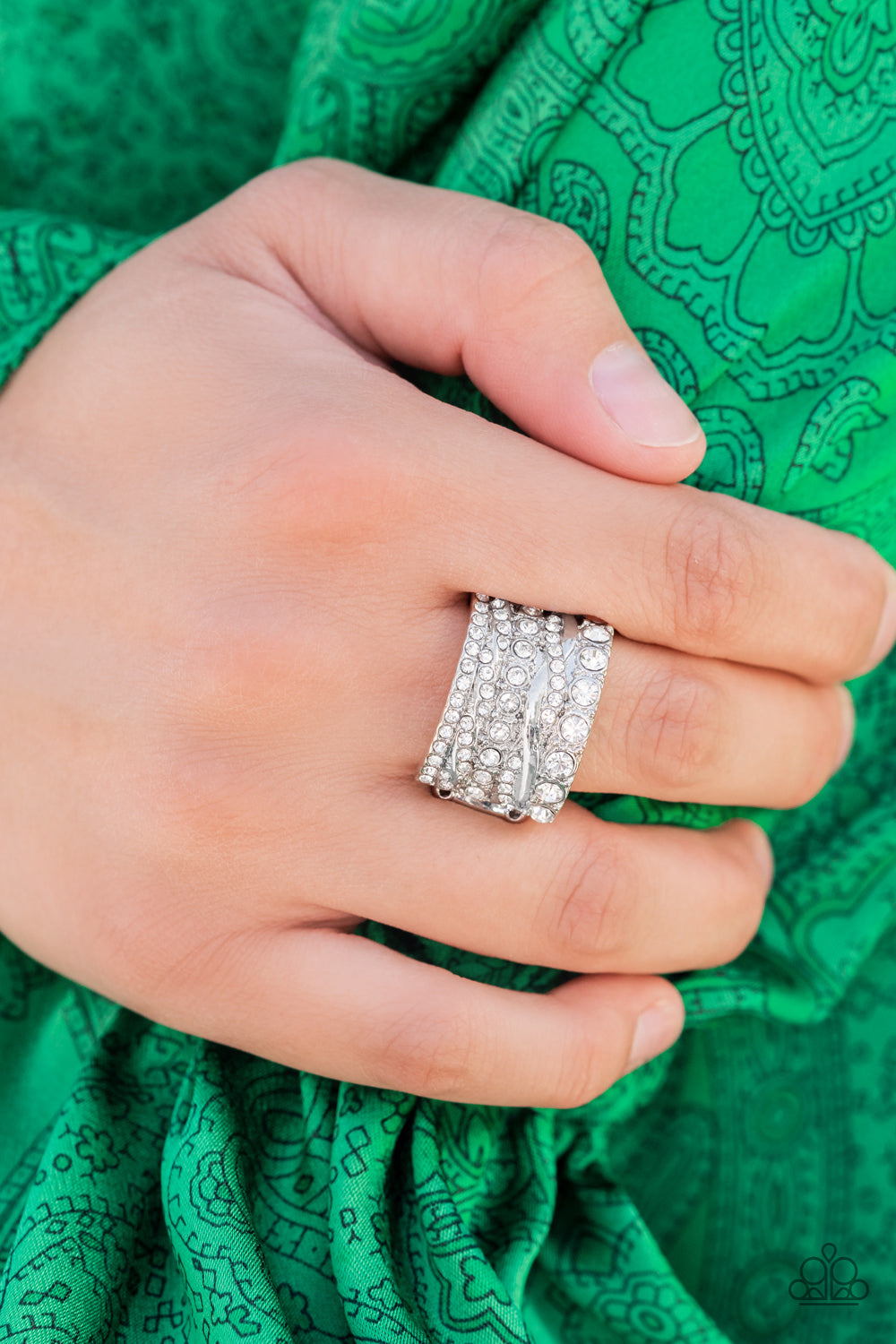 Exclusive Elegance White Ring - Paparazzi Accessories  Row after row of radiantly mismatched white rhinestones and glistening silver bands haphazardly stack across the finger, coalescing into a dramatic display of dazzle. Features a stretchy band for a flexible fit.  All Paparazzi Accessories are lead free and nickel free!  Sold as one individual ring.