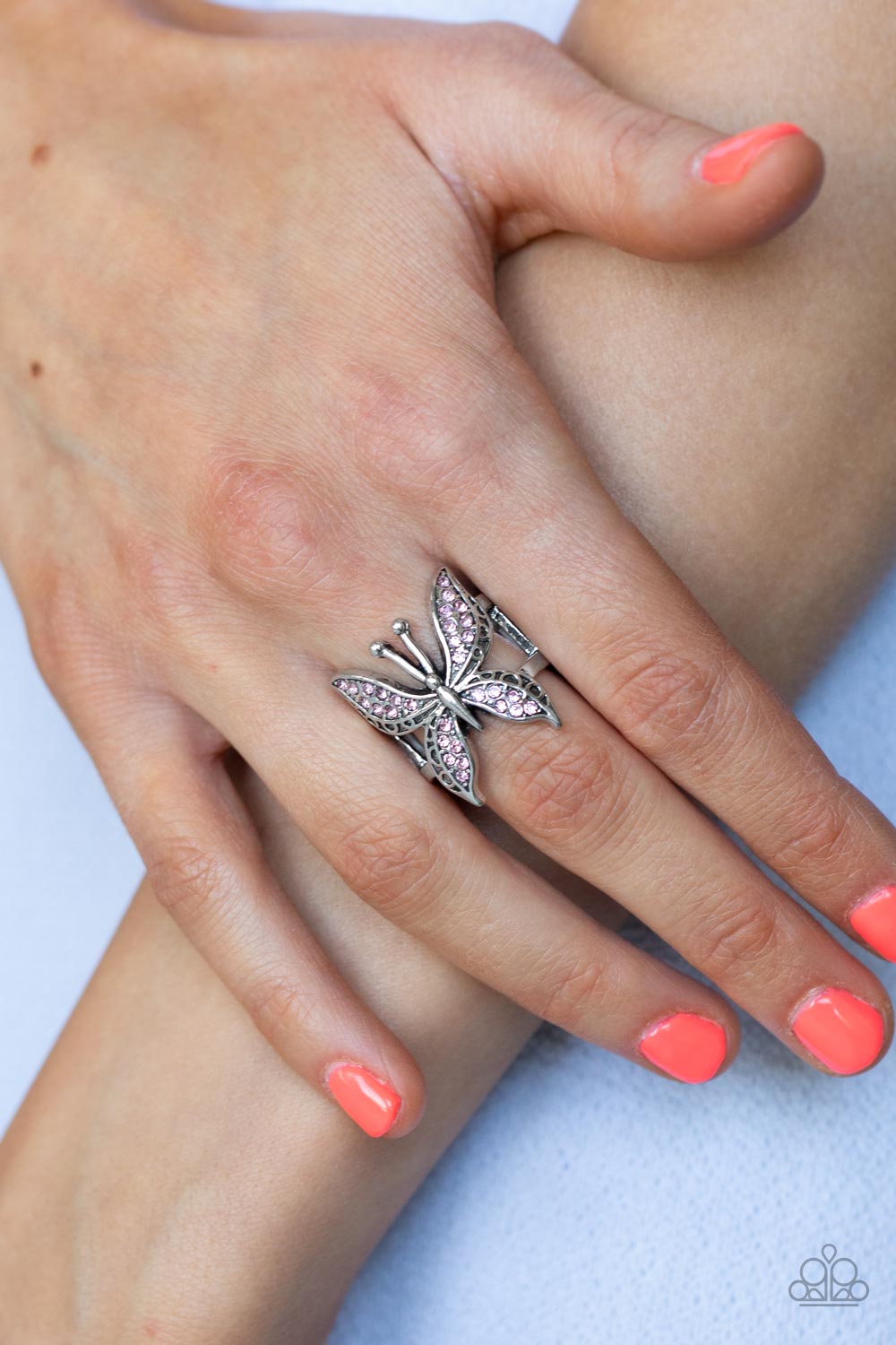 Blinged Out Butterfly Pink Ring - Paparazzi Accessories  Glittery sections of pink rhinestones delicately encrust the decorative wings of a silver butterfly, creating a whimsically fluttering centerpiece atop the finger. Features a stretchy band for a flexible fit.  Sold as one individual ring.