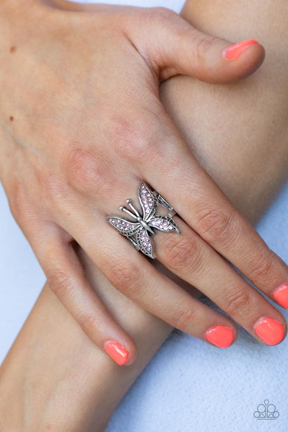 Blinged Out Butterfly Pink Ring - Paparazzi Accessories  Glittery sections of pink rhinestones delicately encrust the decorative wings of a silver butterfly, creating a whimsically fluttering centerpiece atop the finger. Features a stretchy band for a flexible fit.  Sold as one individual ring.