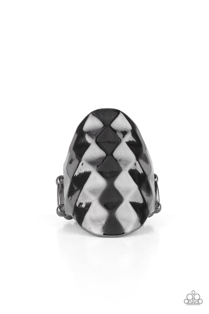 Ferociously Faceted Black Ring - Paparazzi Accessories  The front of a gunmetal oval frame is faceted in a flashy geometric pattern, creating an intense industrial centerpiece around the finger. Features a stretchy band for a flexible fit.  Sold as one individual ring.