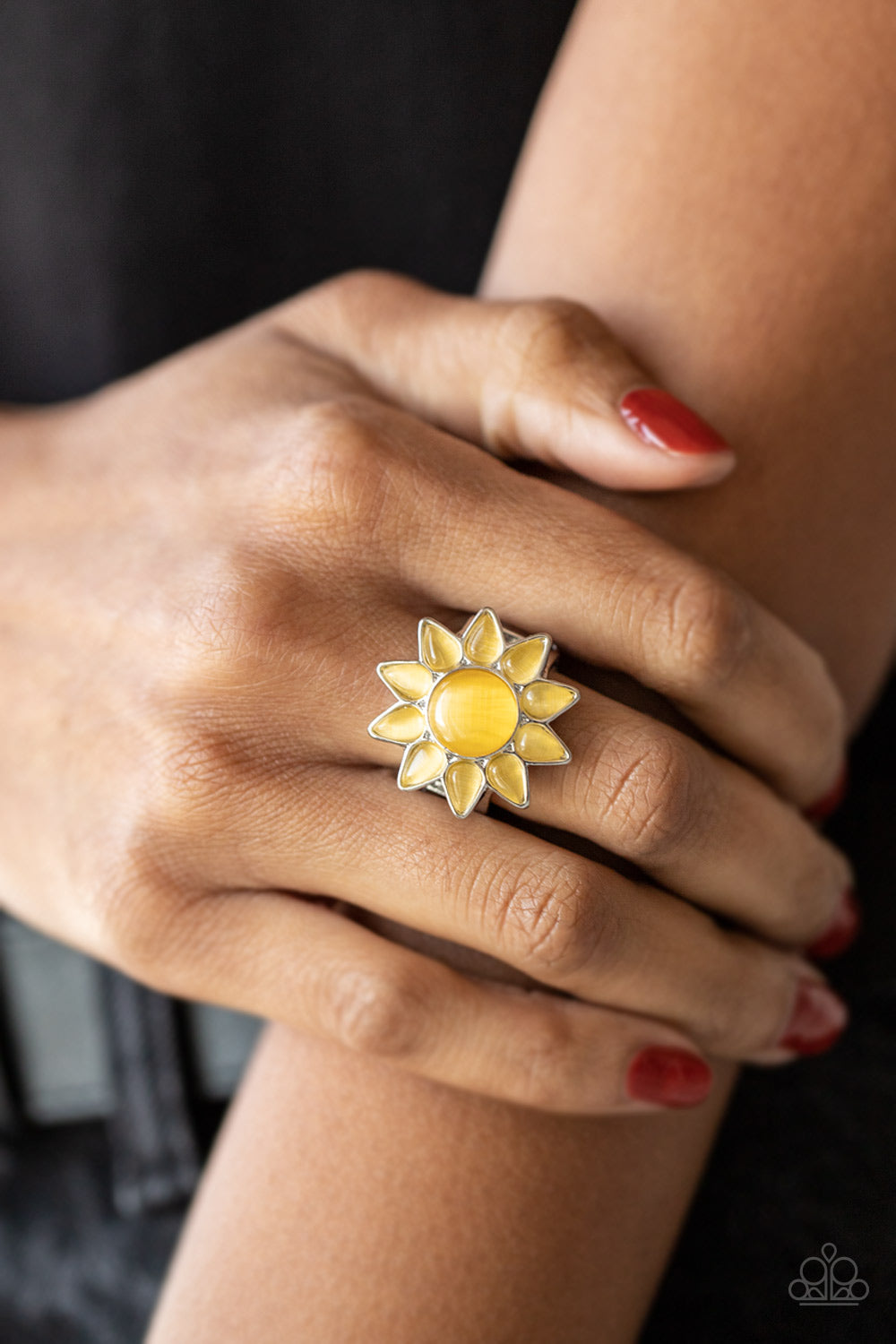 Blossoming Sunbeams Yellow Flower Ring - Paparazzi Accessories  Dainty teardrop yellow cat's eye stones bloom from a round yellow cat's eye stone center, creating a sunny blossom atop the finger. Features a stretchy band for a flexible fit.  Sold as one individual ring.