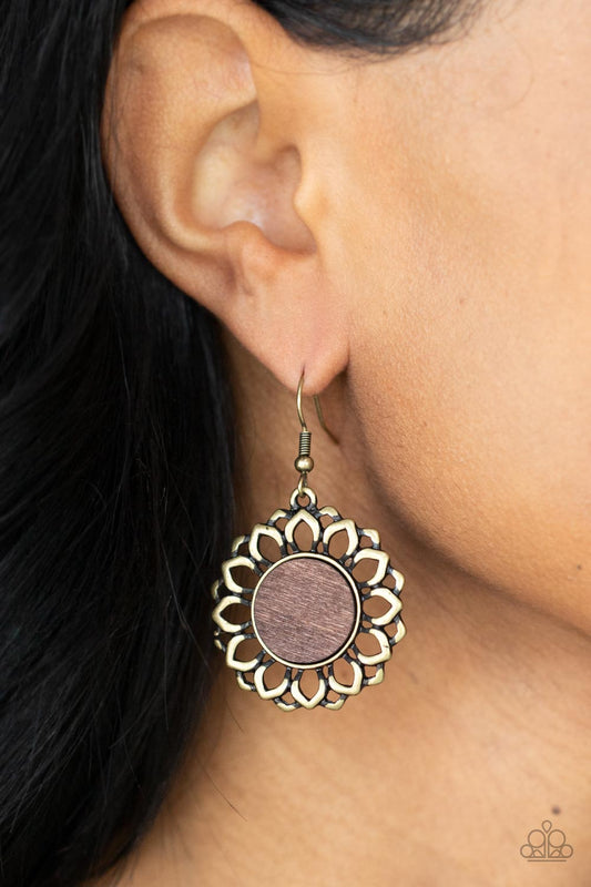 Farmhouse Fashionista Brass Earring - Paparazzi Accessories  Layers of antiqued brass petals bloom from a flat brown wooden center, creating a whimsically rustic display. Earring attaches to a standard fishhook fitting.  Sold as one pair of earrings.
