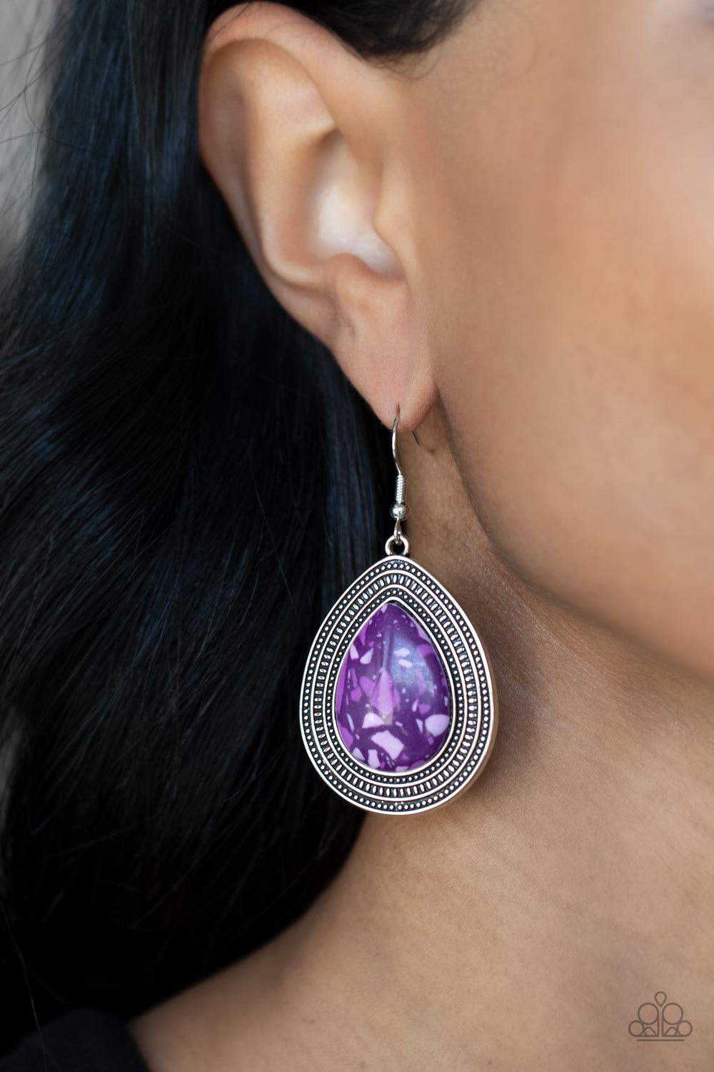 Terrazzo Tundra Purple Earring - Paparazzi Accessories  Featuring a colorful terrazzo pattern, a purple teardrop stone is pressed into the center of a silver frame studded and embossed in borders of tribal inspired textures. Earring attaches to a standard fishhook fitting.  Sold as one pair of earrings.