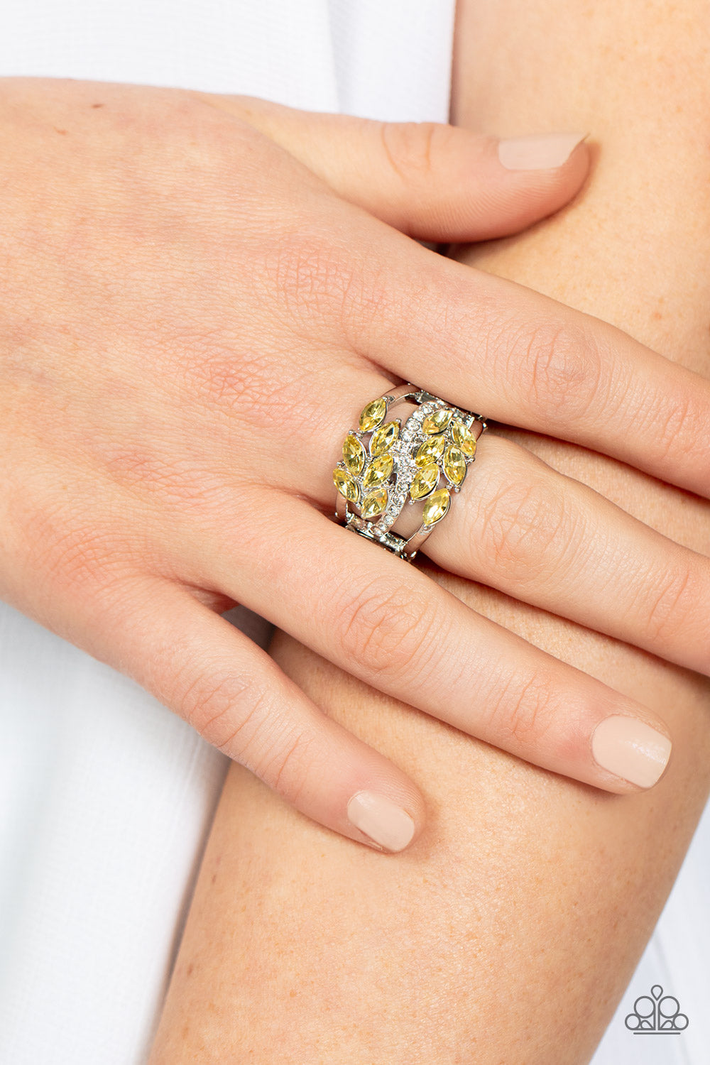 Luminously Leafy Yellow Ring - Paparazzi Accessories Item #P4RE-YWXX-076XX Clusters of yellow marquise-cut crystals flank a wavy band of dainty white rhinestones atop the finger. The yellow crystals fall into a leafy pattern, adding a touch of earthy elegance to the luminously layered look. Features a stretchy band for a flexible fit.  Sold as one individual ring.