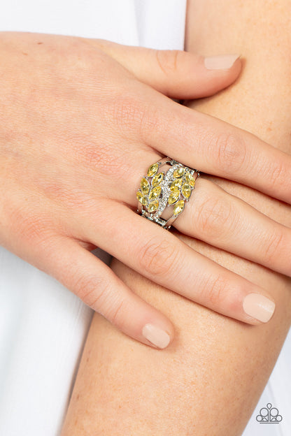 Luminously Leafy Yellow Ring - Paparazzi Accessories Item #P4RE-YWXX-076XX Clusters of yellow marquise-cut crystals flank a wavy band of dainty white rhinestones atop the finger. The yellow crystals fall into a leafy pattern, adding a touch of earthy elegance to the luminously layered look. Features a stretchy band for a flexible fit.  Sold as one individual ring.