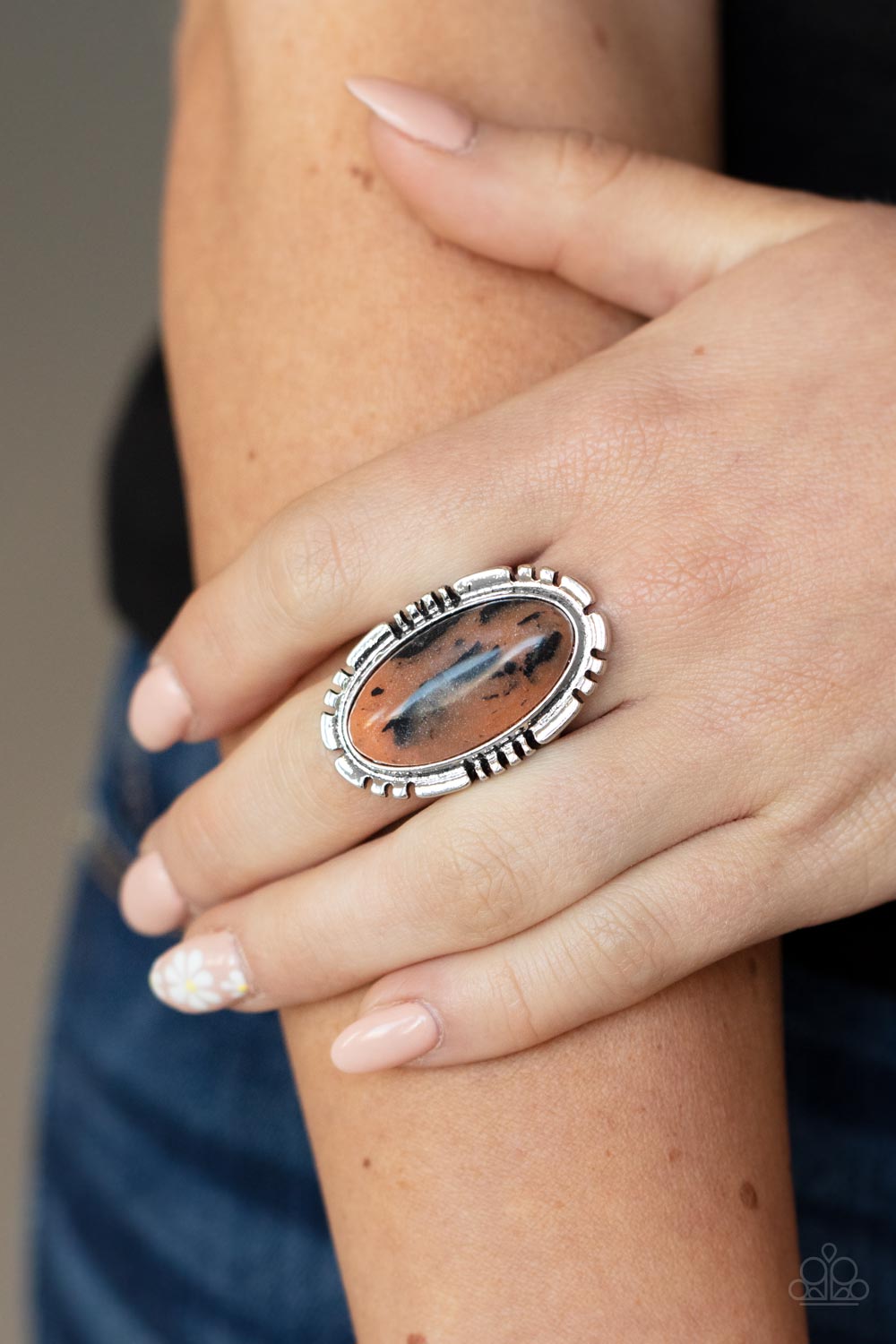 Peacefully Pioneer Brown Ring - Paparazzi Accessories  An earthy brown oval stone is pressed into the center of a textured silver frame, creating an abstract artisanal display atop the finger. Features a stretchy band for a flexible fit.  Sold as one individual ring.