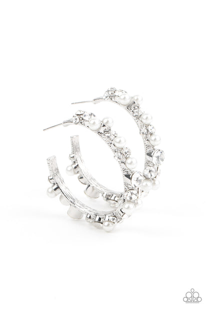 Let There Be SOCIALITE White Hoop Earring - Paparazzi Accessories  A bubbly array of classic white rhinestones and glassy white rhinestones are encrusted along the front of a silver hoop, creating an elegantly effervescent look. Earring attaches to a standard post fitting. Hoop measures approximately 1 1/2" in diameter.  All Paparazzi Accessories are lead free and nickel free!  Sold as one pair of hoop earrings.