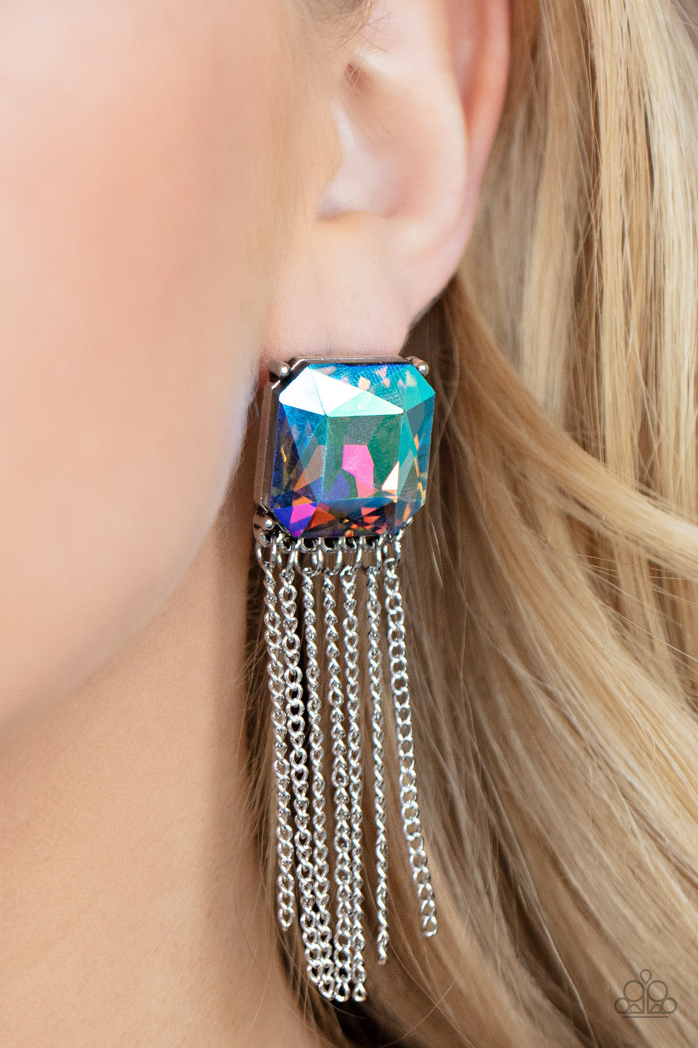 Supernova Novelty Multi Earring - Paparazzi Accessories  Featuring a stellar UV shimmer, an oversized radiant cut gem is pressed into a pronged silver fitting that gives way to a tapered curtain of silver chains for an out-of-this-world finish. Earring attaches to a standard post fitting.  All Paparazzi Accessories are lead free and nickel free!  Sold as one pair of post earrings.