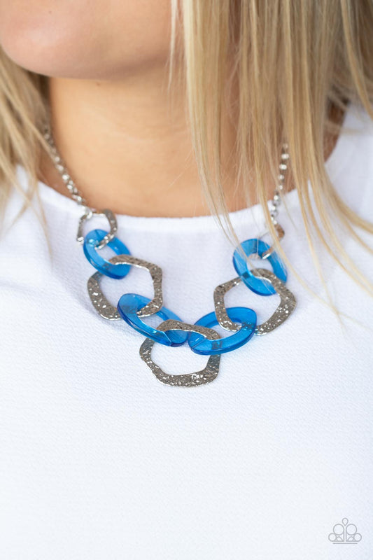Urban Circus Blue Necklace - Paparazzi Accessories  An asymmetrical assortment of neon blue acrylic rings and hammered silver hoops boldly interlock below the collar, creating an intense pop of color. Features an adjustable clasp closure.  All Paparazzi Accessories are lead free and nickel free!   Sold as one individual necklace. Includes one pair of matching earrings.