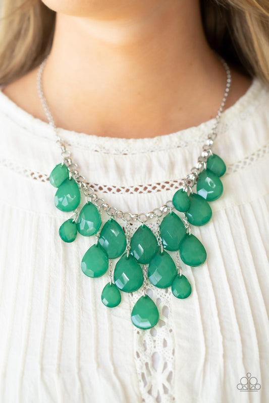 Front Row Flamboyance Green Necklace - Paparazzi Accessories  Varying in size, an opaque collection of faceted Leprechaun teardrops trickle along a chunky silver chain. Infused with dainty silver chains, additional teardrop beads swing from the effervescent fringe at varying lengths for a glamorous finish. Features an adjustable clasp closure.  Sold as one individual necklace. Includes one pair of matching earrings.
