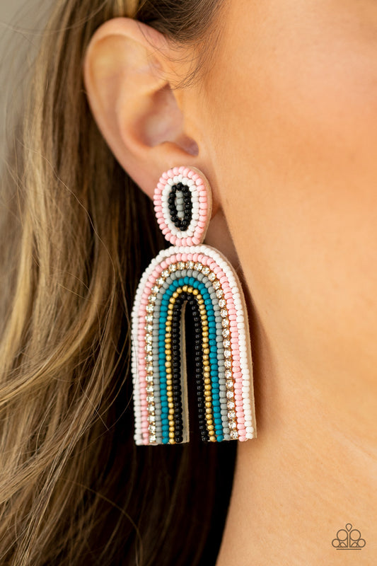 Rainbow Remedy Multi Seed Bead Earring - Paparazzi Accessories  Infused with a single row of glassy white rhinestones, dainty strands of white, pink, gray, blue, gold, and black seeds stack into a colorful rainbow at the bottom of a matching seed beaded fitting. Earring attaches to a standard post fitting.  Sold as one pair of post earrings.