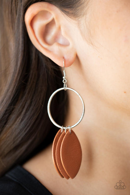 Leafy Laguna Brown Leather Earring - Paparazzi Accessories  Leafy Adobe leather frames swing from the bottom of a textured silver hoop, creating an earthy fringe. Earring attaches to a standard fishhook fitting.  All Paparazzi Accessories are lead free and nickel free!  Sold as one pair of earrings.