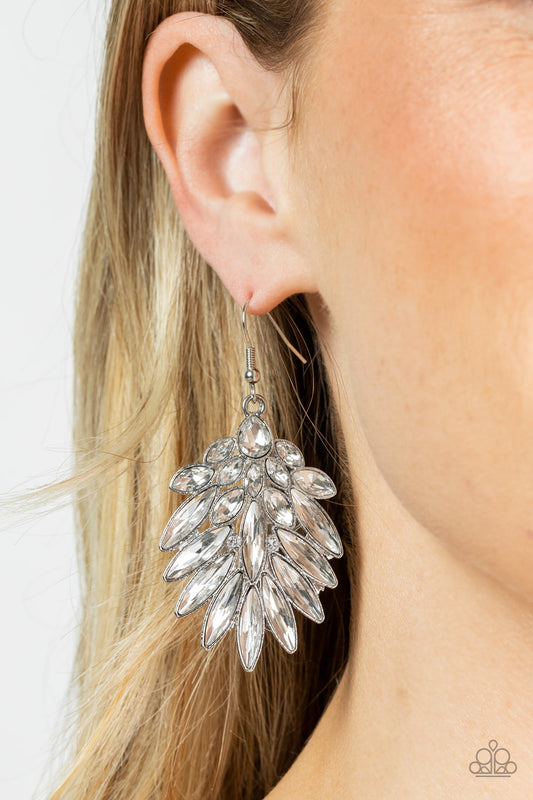 COSMIC-politan White Earring - Paparazzi Accessories  A glassy white teardrop rhinestone gives way to a sparkly fan of classic white and oblong marquise cut rhinestones, coalescing into an out-of-this-world statement piece. Earring attaches to a standard fishhook fitting.  Sold as one pair of earrings.