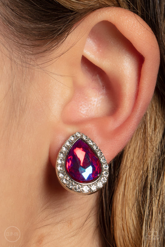 Cosmic Castles Pink Clip-On Earring - Paparazzi Accessories  Featuring a flashy UV finish, a faceted pink teardrop gem is pressed into a silver frame bordered with glittery white rhinestones for a glamorous finish. Earring attaches to a standard clip-on fitting.  Sold as one pair of clip-on earrings.