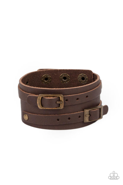 Bronco Bustin Buckles Brass Wrap Bracelet - Paparazzi Accessories   A pair of brown leather brass buckles are buckled in place across the front of a rustic brown leather band for a seasonal look. Features an adjustable snap closure.  Sold as one individual bracelet.