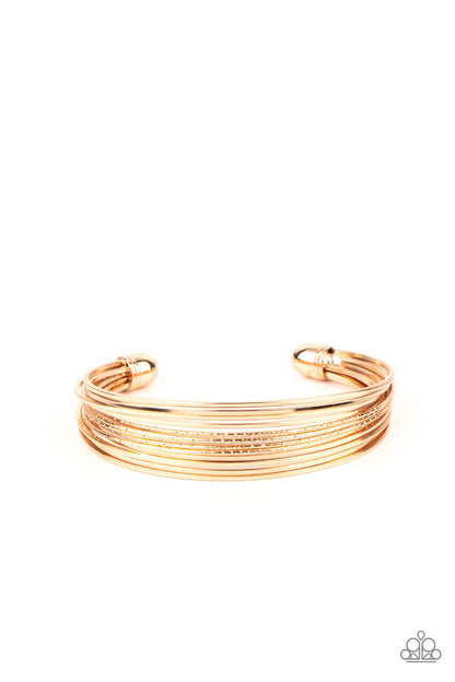 This Girl is on WIRE - Gold Item #P9BA-GDXX-094XX Capped in gold fittings, rows of smooth gold wires flank a section of diamond cut gold wire around the wrist, creating an edgy cuff.  Sold as one individual bracelet.