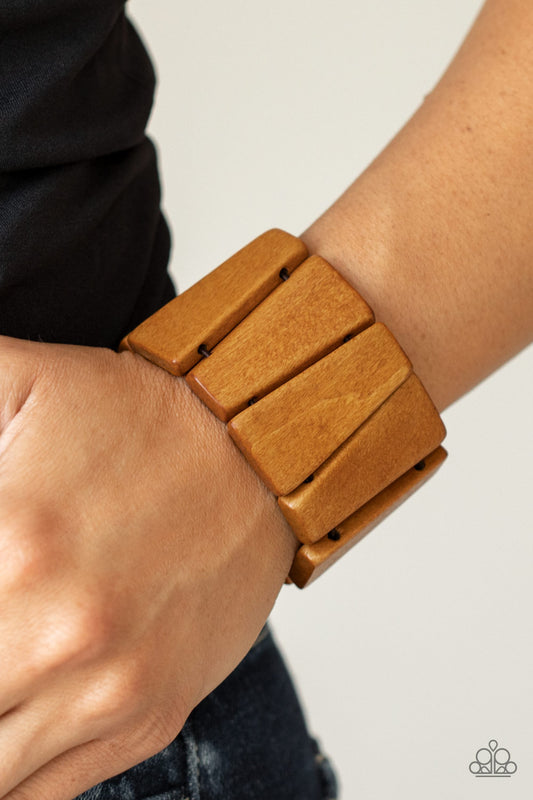 Barbados Backdrop Brown Stretch Bracelet - Paparazzi Accessories  Polished in a natural brown finish, chunky triangular wooden frames are threaded along stretchy bands around the wrist for an earthy look.  Sold as one individual bracelet.