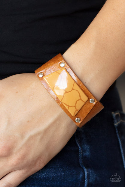 Geo Glamper Brown Wrap Bracelet - Paparazzi Accessories  Featuring a faux marble finish, a brown acrylic centerpiece attaches to a tan leather frame that is studded in place along a distressed tan leather band for a colorfully rustic fashion. Features an adjustable snap closure.  Sold as one individual bracelet.