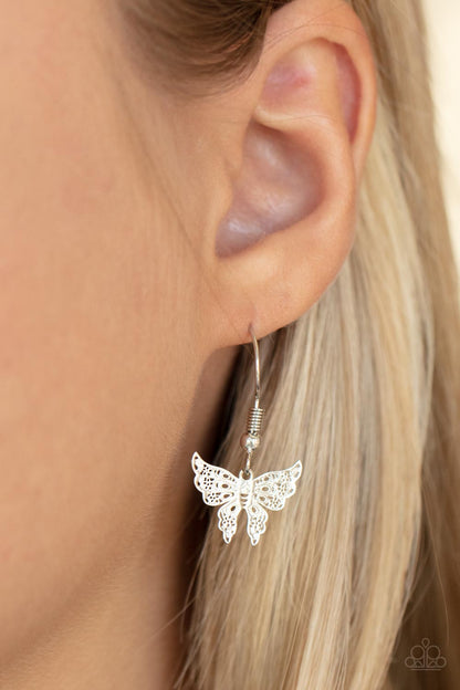 Bountiful Butterflies White Necklace - Paparazzi Accessories  Dotted with a dainty white rhinestone, a decoratively layered silver butterfly swings from the bottom of a display of mismatched silver chains for a whimsically fluttering fashion. Features an adjustable clasp closure.  Sold as one individual necklace. Includes one pair of matching earrings.