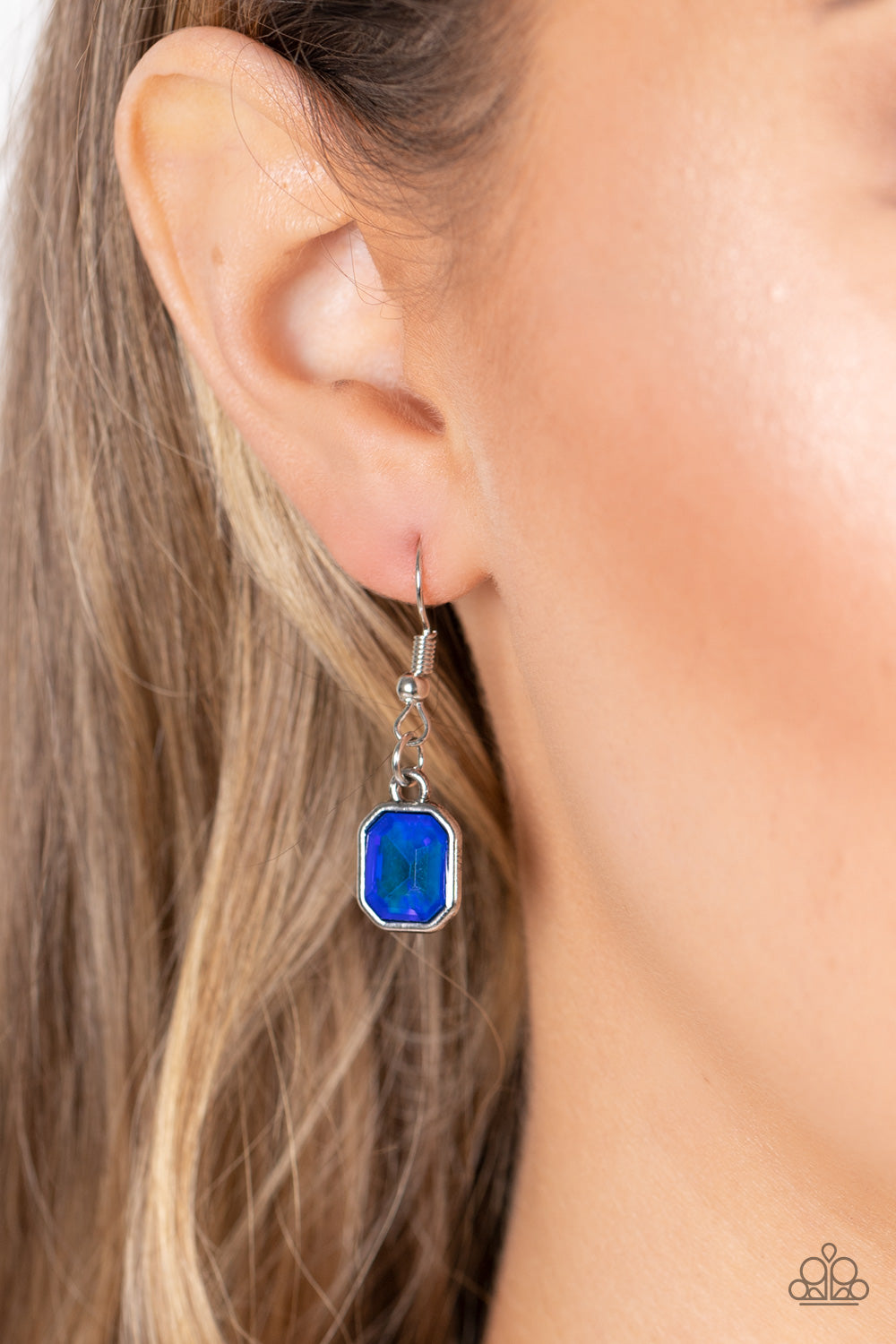 Divine IRIDESCENCE Blue Necklace - Paparazzi Accessories  Featuring a subtle UV shimmer, an oversized collection of radiant cut blue gems delicately link at the bottom of two curved silver rods. Attached to shiny silver chains, the glamorously glitzy display sparkles below the collar for a jaw-dropping finish. Features an adjustable clasp closure.  All Paparazzi Accessories are lead free and nickel free!  Sold as one individual necklace. Includes one pair of matching earrings.