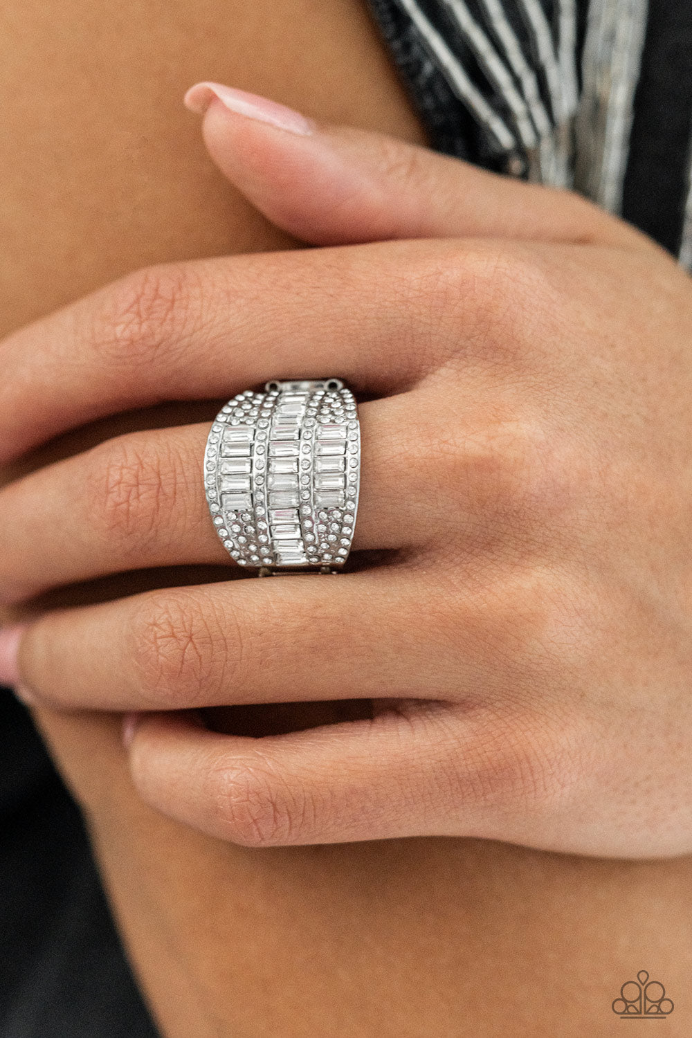 Red Carpet Redux White Ring - Paparazzi Accessories  The front of a silver oval frame is encrusted in stacked rows of emerald and round cut white rhinestones, coalescing into a blinding centerpiece atop the finger. Features a stretchy band for a flexible fit.  Sold as one individual ring.