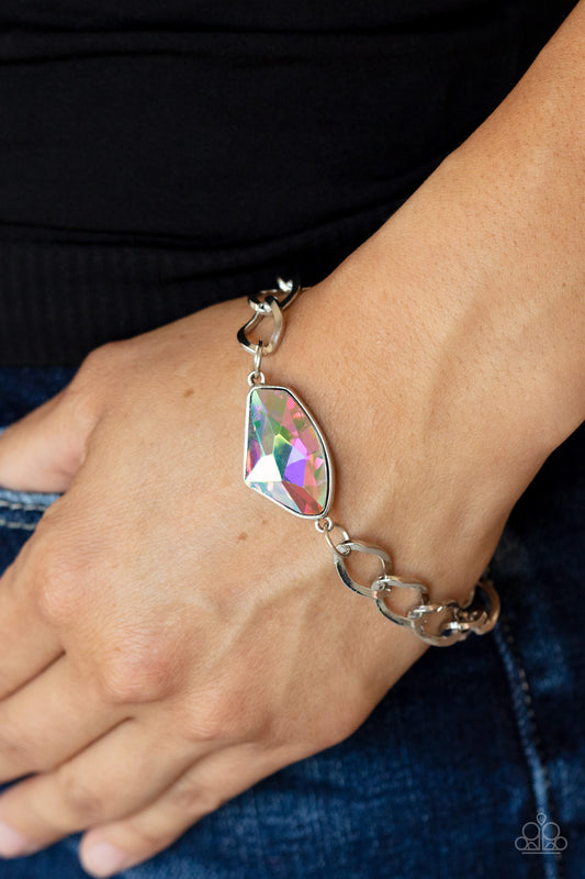 Galactic Grunge Multi Bracelet - Paparazzi Accessories  Featuring a UV shimmer, a raw cut multi gem is pressed into a sleek silver frame that attaches to a bold silver chain around the wrist for a glitzy grunge fashion. Features an adjustable clasp closure.  Sold as one individual bracelet.