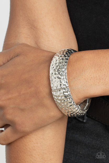 Come Under The Hammer Silver Bracelet - Paparazzi Accessories  Hammered in rustic textures, curved silver rectangular frames are threaded along stretchy bands around the wrist for an artisan inspired look.  Sold as one individual bracelet.