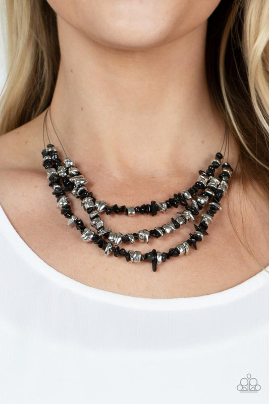 Placid Pebbles Black Necklace - Paparazzi Accessories  An earthy collection of raw cut silver and black pebbles are threaded along dainty wires below the collar, creating refreshing layers. Features an adjustable clasp closure.  Sold as one individual necklace. Includes one pair of matching earrings.