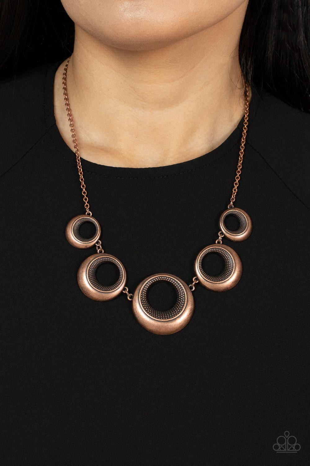 Solar Cycle Copper Necklace - Paparazzi Accessories  Featuring studded centers, an antiqued collection of beveled copper hoops gradually increase in size as they link below the collar for a bold metallic look. Features an adjustable clasp closure.  Sold as one individual necklace. Includes one pair of matching earrings.