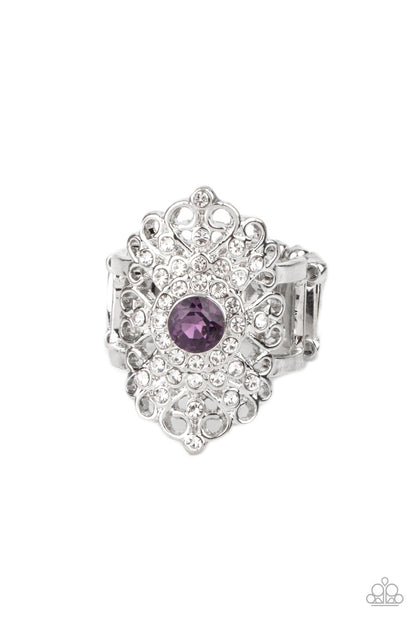 Dining with Royalty Purple Ring - Paparazzi Accessories  A glittery purple rhinestone adorns the center of a frilly silver backdrop adorned in dainty white rhinestones, creating a regal centerpiece atop the finger. Features a stretchy band for a flexible fit.  All Paparazzi Accessories are lead free and nickel free!   Sold as one individual ring.