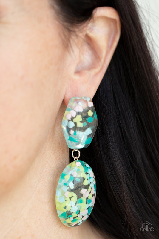 Flaky Fashion Multi Earring - Paparazzi Accessories  Featuring multicolored confetti-like flakes, a clear acrylic oval frame swings from the bottom of a matching hexagonal frame, creating a bubbly lure. Earring attaches to a standard post fitting.  All Paparazzi Accessories are lead free and nickel free!  Sold as one pair of post earrings.