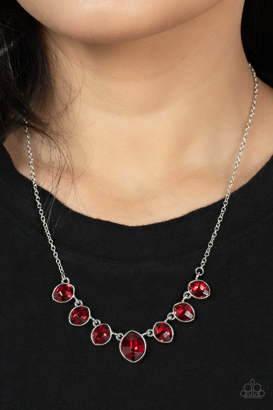 Material Girl Glamour Red Necklace - Paparazzi Accessories  Encased in sleek silver fittings, elegant cut fiery red rhinestones delicately connect below the collar. An oversized red rhinestone adorns to the middle of the glittery strand, creating a sparkly centerpiece. Features an adjustable clasp closure.  All Paparazzi Accessories are lead free and nickel free!  Sold as one individual necklace. Includes one pair of matching earrings.