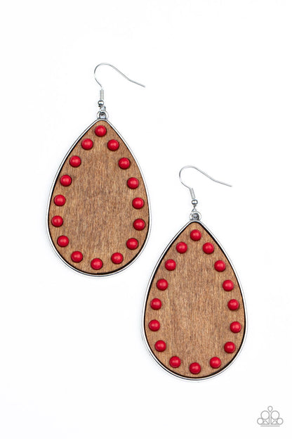 Rustic Refuge Red Earring - Paparazzi Accessories  Dainty red stone beads border an earthy wooden teardrop frame that is encased in a sleek silver fitting, creating a whimsical woodsy lure. Earring attaches to a standard fishhook fitting.  Sold as one pair of earrings.