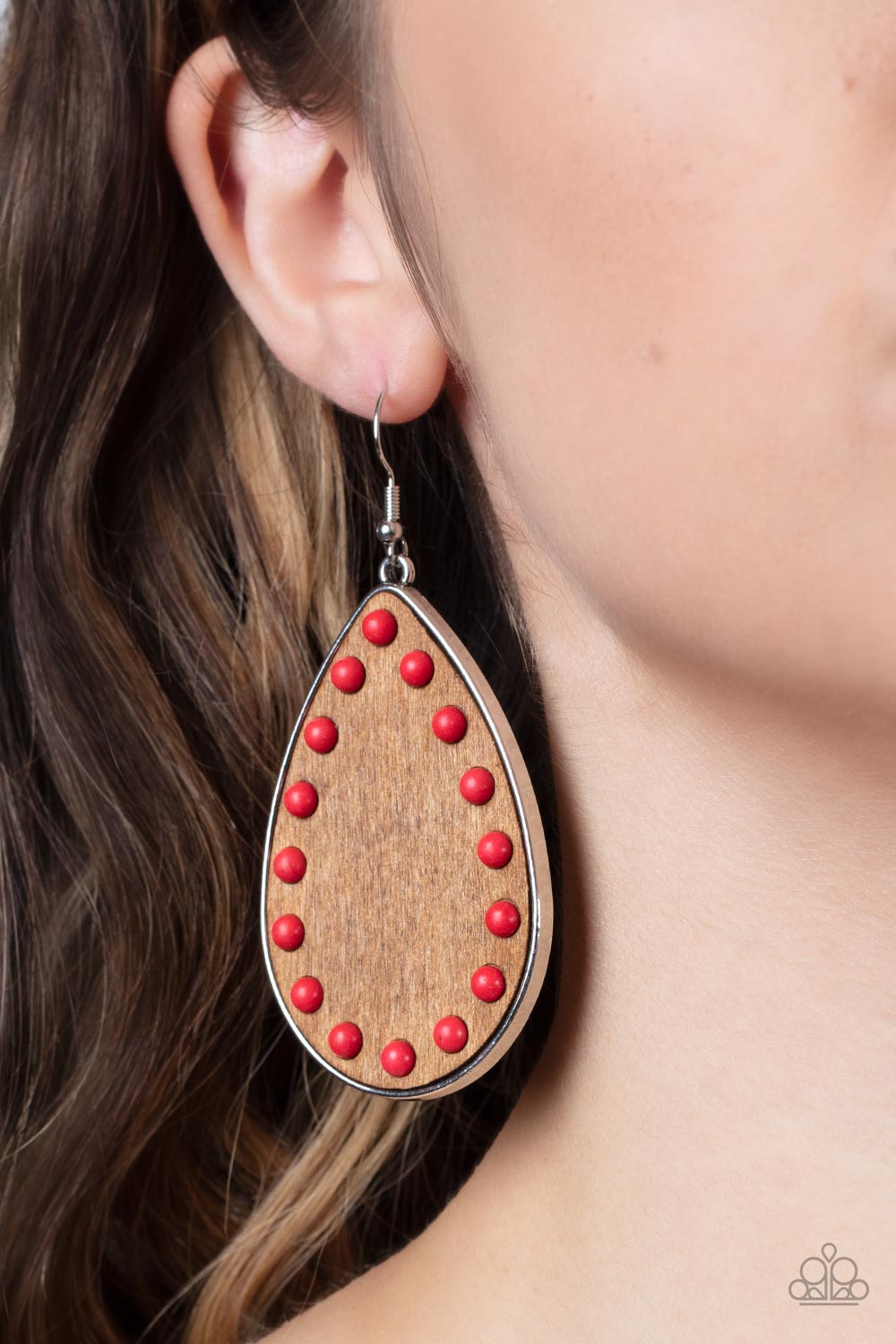 Rustic Refuge Red Earring - Paparazzi Accessories  Dainty red stone beads border an earthy wooden teardrop frame that is encased in a sleek silver fitting, creating a whimsical woodsy lure. Earring attaches to a standard fishhook fitting.  Sold as one pair of earrings.
