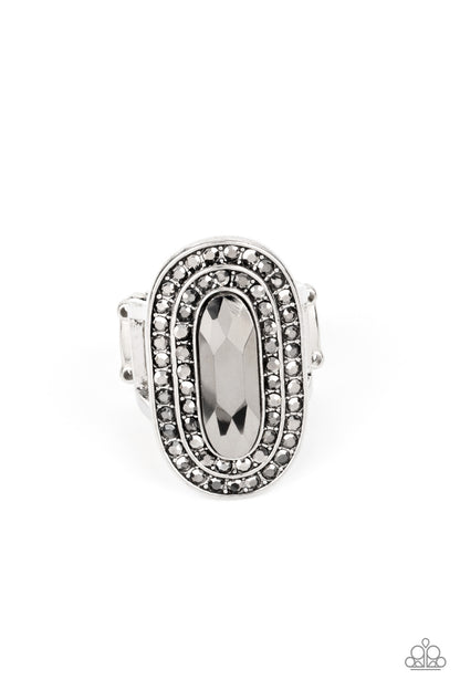 Fueled by Fashion Silver Ring - Paparazzi Accessories  An elongated sparkling hematite gem is nestled inside a linear silver frame created by double rows of dainty hematite rhinestones. The faceted gem creates a glamorously edgy effect atop the finger. Features a stretchy band for a flexible fit.  Sold as one individual ring.