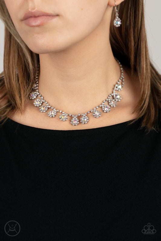Princess Prominence Multi Choker Necklace - Paparazzi Accessories  A dainty strand of glittery white rhinestones encircle solitaire iridescent rhinestones around the neck, creating a glitzy fringe. Features an adjustable clasp closure.  Sold as one individual choker necklace. Includes one pair of matching earrings.