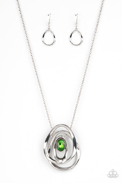 Luminous Labyrinth - Green Item #P2IN-GRXX-044XX An oversized glittery green gem seemingly floats inside an asymmetrical silver oval that glides between two oversized silver ovals at the bottom of an extended silver chain, creating an edgy pendant. Features an adjustable clasp closure.  Sold as one individual necklace. Includes one pair of matching earrings.