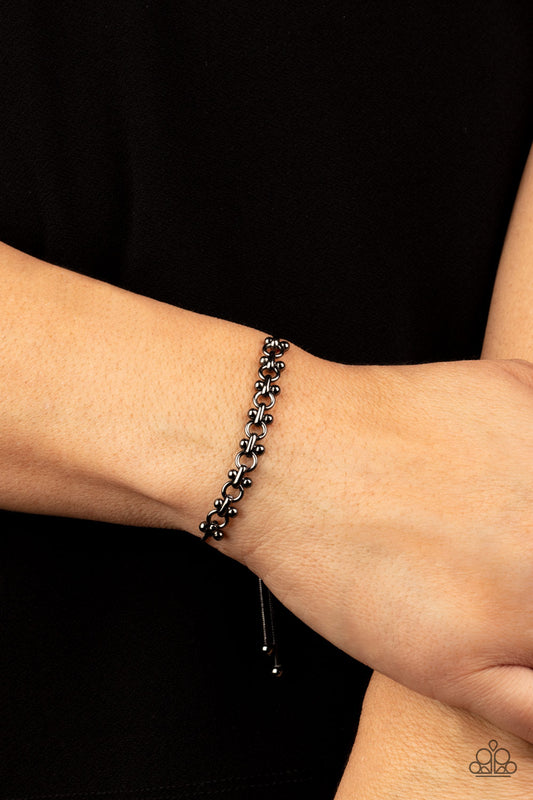 Slide On Over Black Bracelet - Paparazzi Accessories  A dainty section of gunmetal beaded fittings and gunmetal links delicately attaches to a rounded gunmetal snake chain around the wrist, creating a sleek metallic shimmer. Features an adjustable sliding bead closure.  Sold as one individual bracelet.